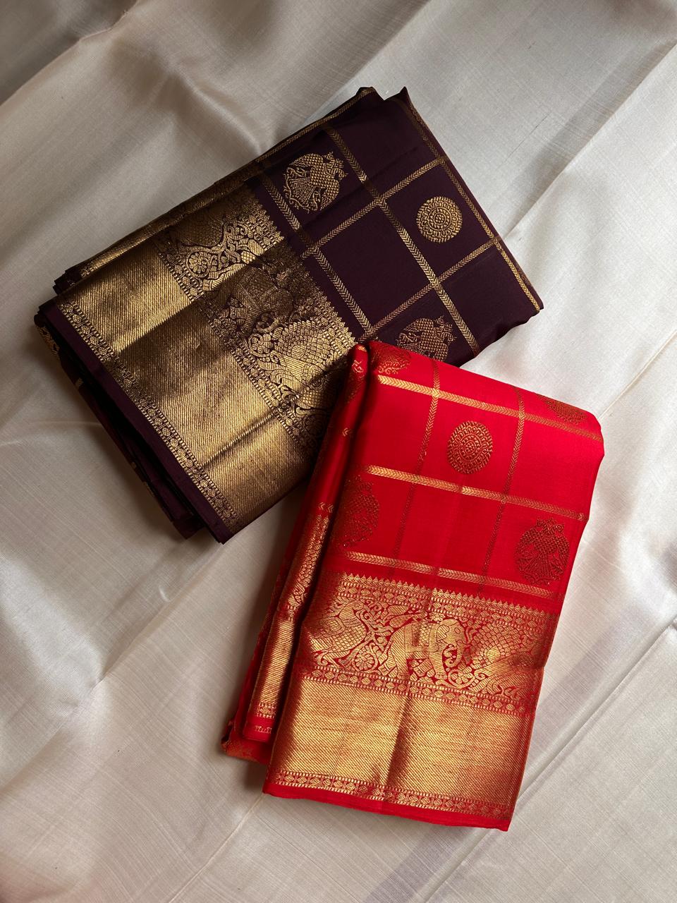 Ambaram – Coffee Brown
 — Pure Kanchipuram Silk
Elephant & Peacock Procession Zari Border • Coin & Gandaberunda Buttas
Geometric Diamond Brocade Pallu in Antique Gold
Handloom •
Silk Mark Certified • Ships in Two Weeks
