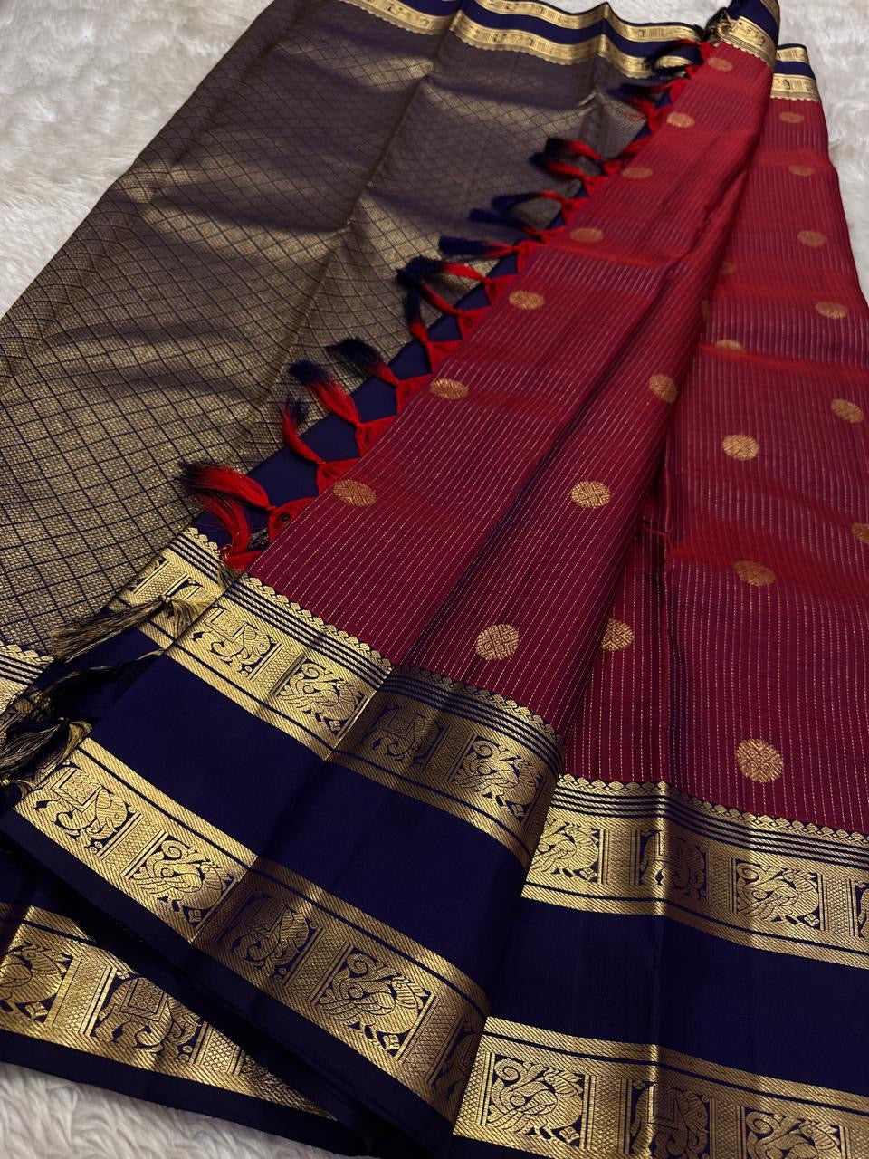 Anuraaga – Neelam
 — Pure Kanchipuram Silk
Vertical Pin-Stripe (Vairaoosi) Body • Gold Coin Buttas
Navy (Neelam) Korvai Border with Elephant Motifs
Diamond-Jaal Brocade Pallu • Running Contrast Blouse
Silk Mark Certified • free shipping in Two Weeks