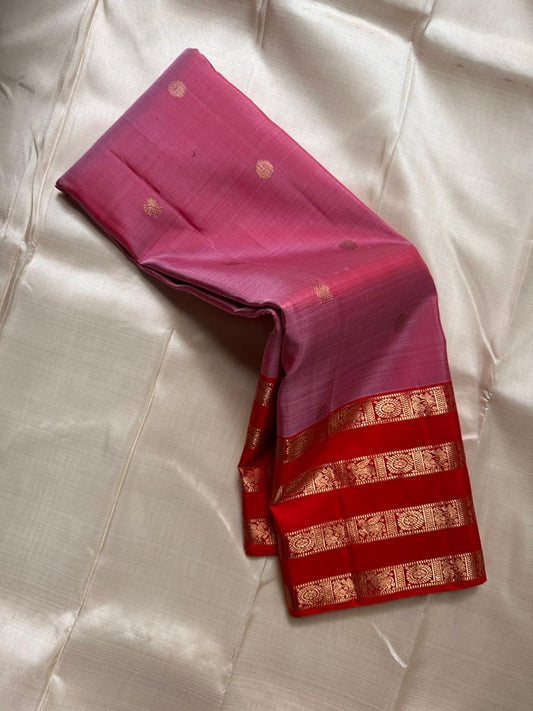 Thamarai Vermillion — Pure Kanchipuram Silk Saree
Soft orchid-pink body with zari lotus buttas and striking vermillion korvai borders, finished with a radiant orange pallu in intricate zari weave.
Silk Mark Certified • Blouse Stitching Available ($30) •