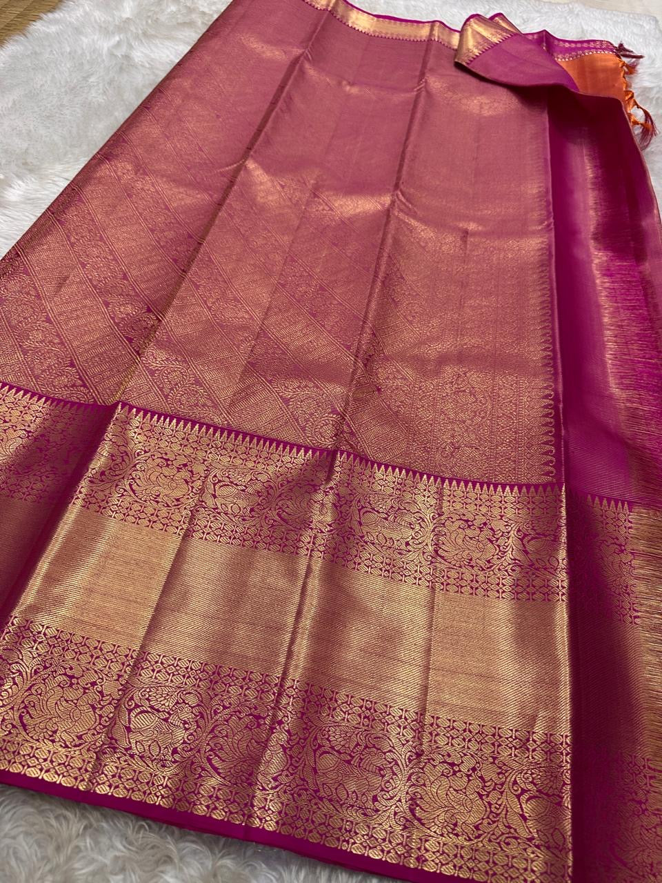 Vairaoosi - silk Kanchipuram thanga velli ( sonaroopa) zari butta in a mesmerizing rust red korvai getti (thick ) zari border with mayil motif