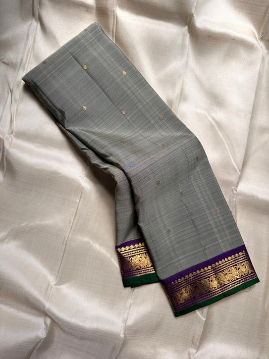 Dove Gray Mayuri — Pure Kanchipuram Silk Saree ✨
Soft dove-gray body with gold coin buttas, violet borders & emerald selvedge 💜
Silk Mark Certified ✅ | ships in two weeks