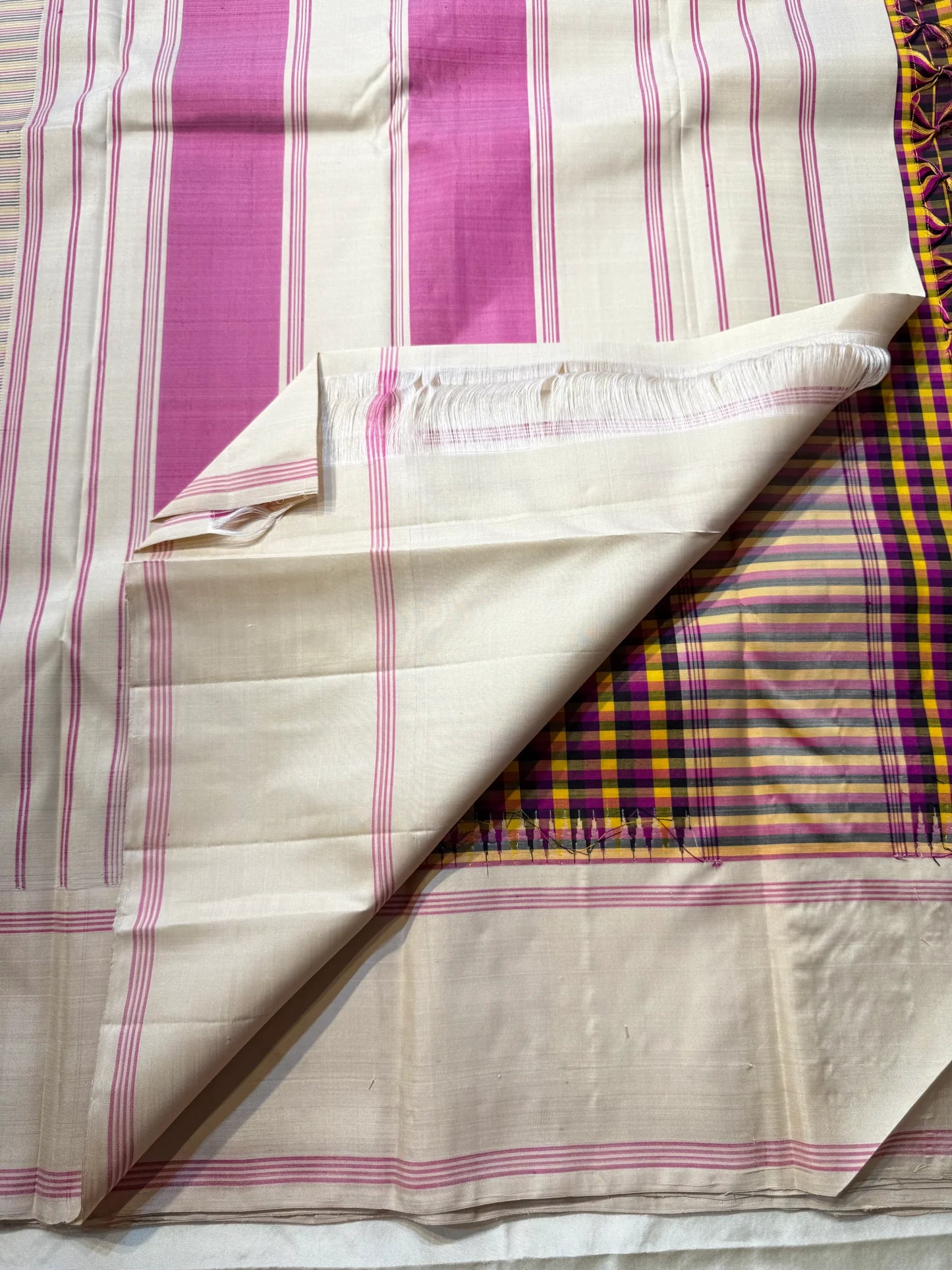 Venpattu Kattam Thazampoo Reku — Pure Kanchipuram Silk Saree
Multicolor kattam body: rani pink • manjal yellow • ink blue/black • deep purple/green accents
(venpattu) borders with pink selvedge lines & thazampoo reku 
Silk Mark Certified  free shipping