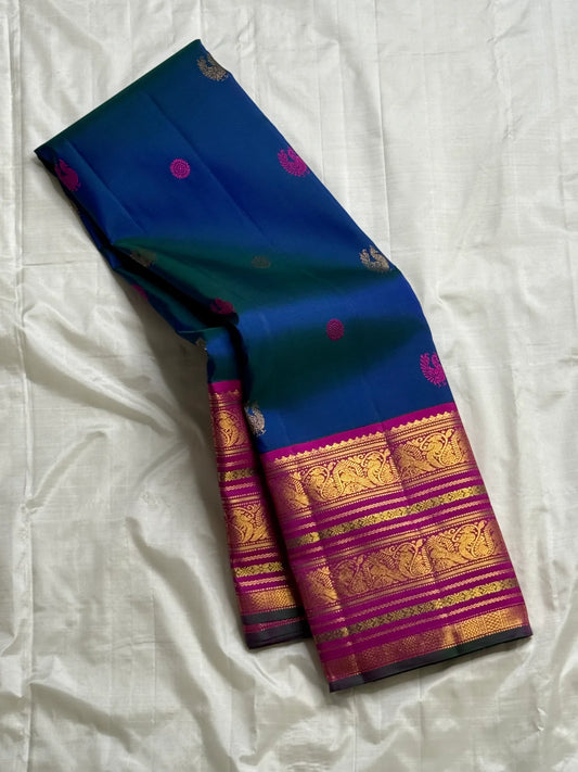Starry Night — Pure Silk Kanchipuram Saree
Dual-tone Teal Blue with Magenta & Gold Paisley Buttas ✨
Silk Mark Certified ✅ | Ships in Two Weeks | Free USA Shipping 🇺🇸