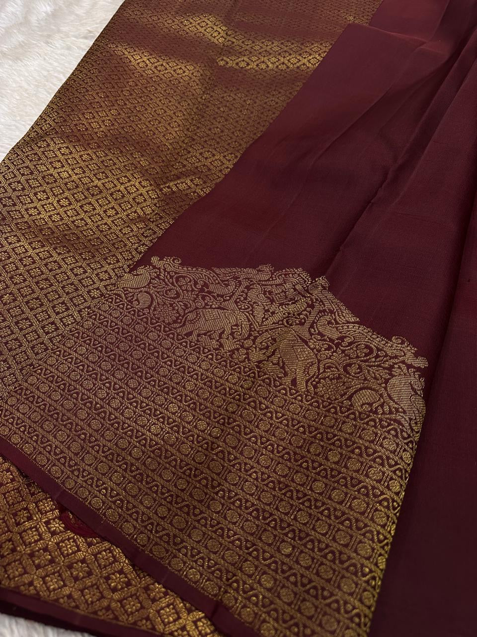 Lotus Glow — Brown | Pure Kanchipuram Silk Saree
A regal brown-maroon canvas adorned with gold zari peacocks, elephants & lotus buttas ✨
Silk Mark Certified • Free USA Shipping • Ships in Two Weeks