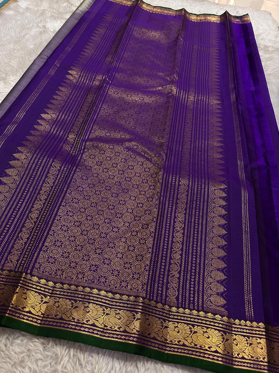 Dove Gray Mayuri — Pure Kanchipuram Silk Saree ✨
Soft dove-gray body with gold coin buttas, violet borders & emerald selvedge 💜
Silk Mark Certified ✅ | ships in two weeks