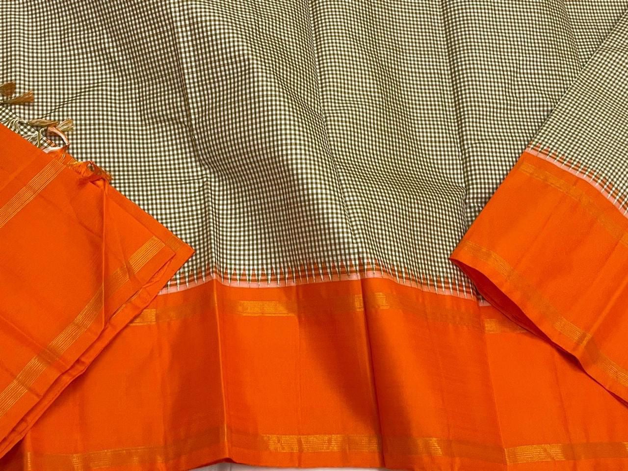 Rust Kattam Korvai – Pure Silk Kanchipuram Saree
Olive–Ivory Micro-Checks Body with Korvai Join
Rust Orange Border
Rust Orange Pallu pillayar Reku
Comes with Matching Rust Orange Blouse Piece with Zari Border silk mark certified - ships in 2 weeks
