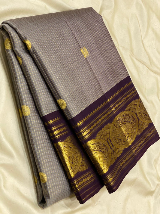 Zari Kattam Dovetail Gray & Deep Purple – Pure Silk Kanchipuram Saree
Fine kattam checks with coin & paisley zari buttas across the body
Deep purple border with annapakshi ships in 1 week silk mark certified, blouse stocking ($30)