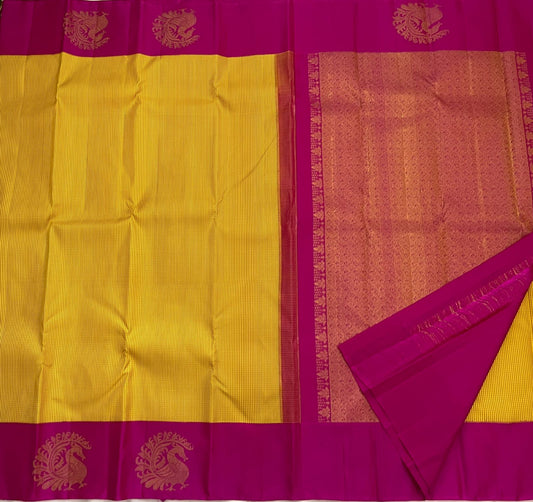 Kanakambari — Pure Kanchipuram Silk Saree (Haldi Yellow × Rani Magenta)
Vibrant haldi-yellow micro-checked body with antique zari peacock motifs on korvai magenta borders
Silk Mark Certified • Fall & Pico Done • Blouse Stitching Available ($30) • Free Shi