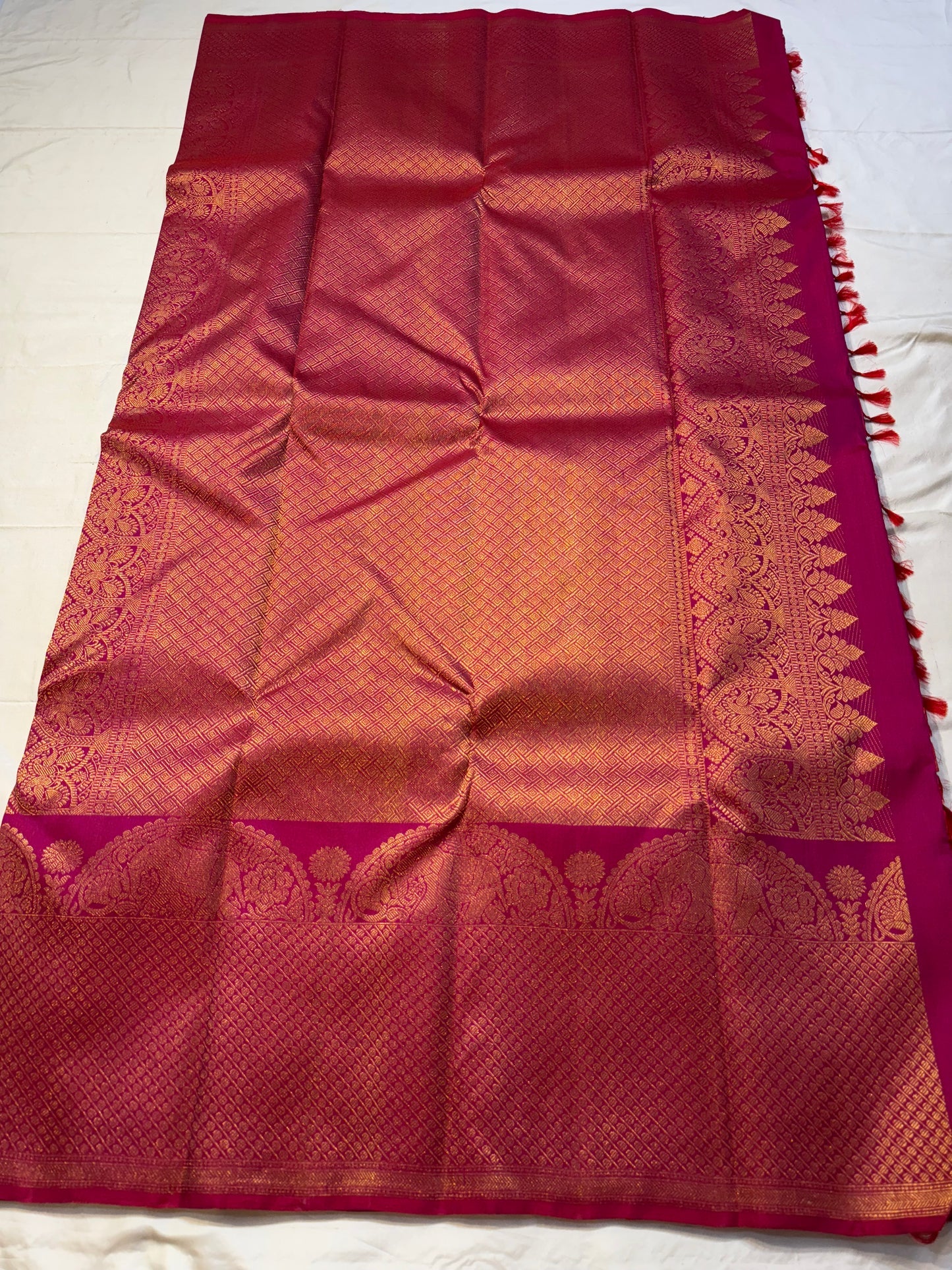 Rosette Bloom — Pure Kanchipuram Silk Saree
Vibrant rani-pink body with copper-rose zari buttas, elephant motifs & floral borders
Silk Mark Certified • Blouse Stitching ($30) • Free Shipping within USA • Ships in Two Weeks