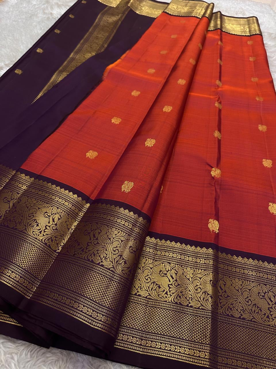 Shyama – Dusky Tangerine Kanchipuram Silk Saree with Purple Vanasringaram Border & Mayil Buttas