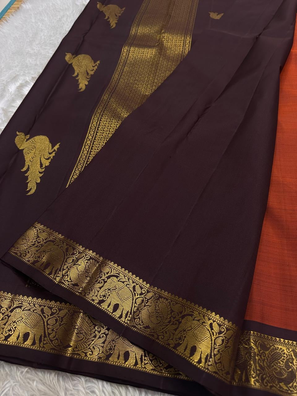 Rust Orange Kili — Pure Silk Kanchipuram Saree
Rust-orange body with gold zari kili (parrot) motifs ✨
Deep coffee-brown korvai borders & grand brocade pallu
Silk Mark Certified • Ships in Two Weeks • Free Shipping within USA