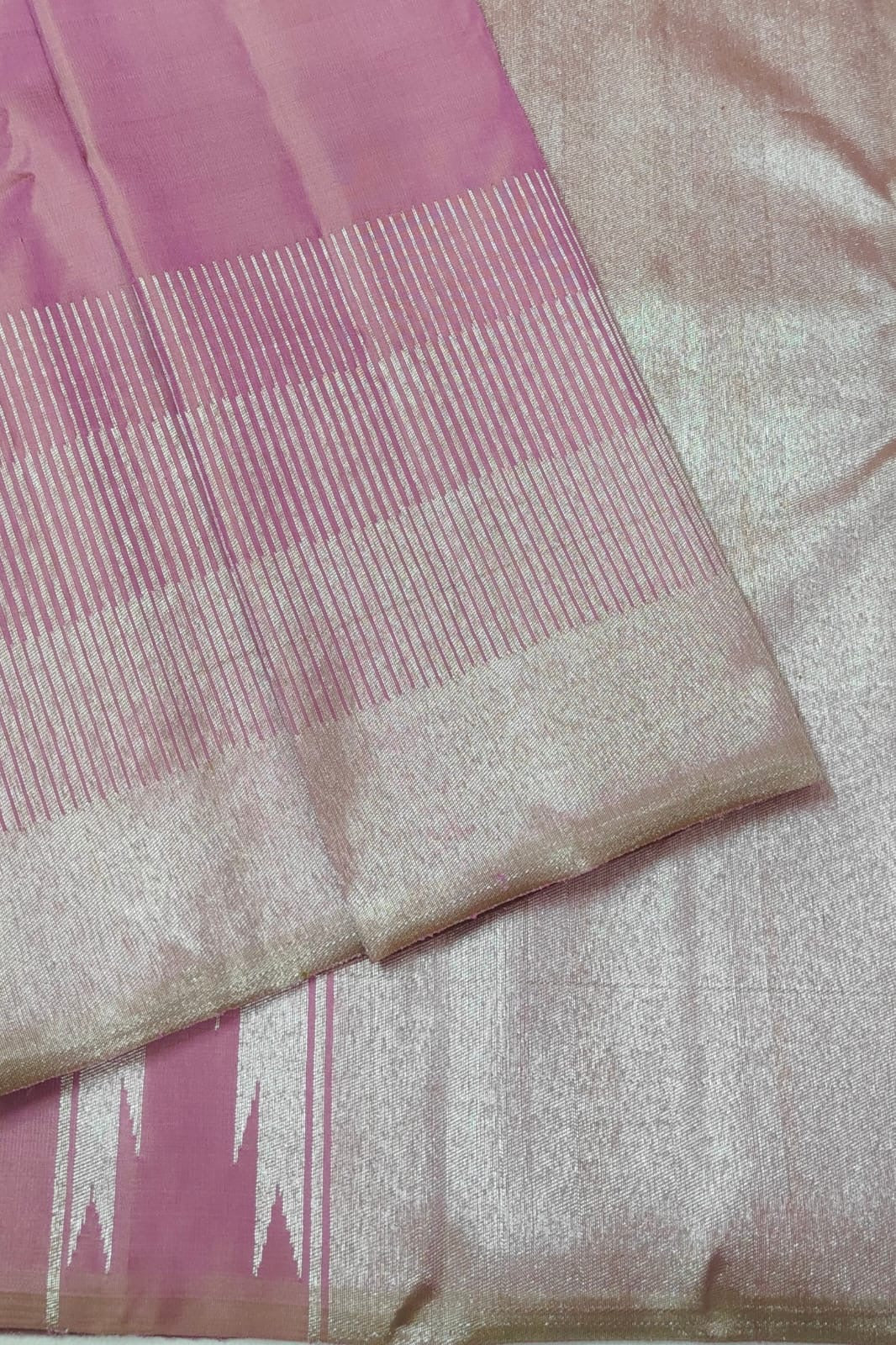 Close-up of a pink and beige fabric with a subtle pattern