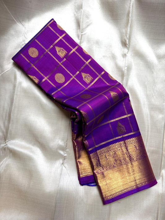 Leelavati Kattam
Amethyst Purple Kanchipuram Silk Saree
Zari-Woven Checks with Elephant Procession Border