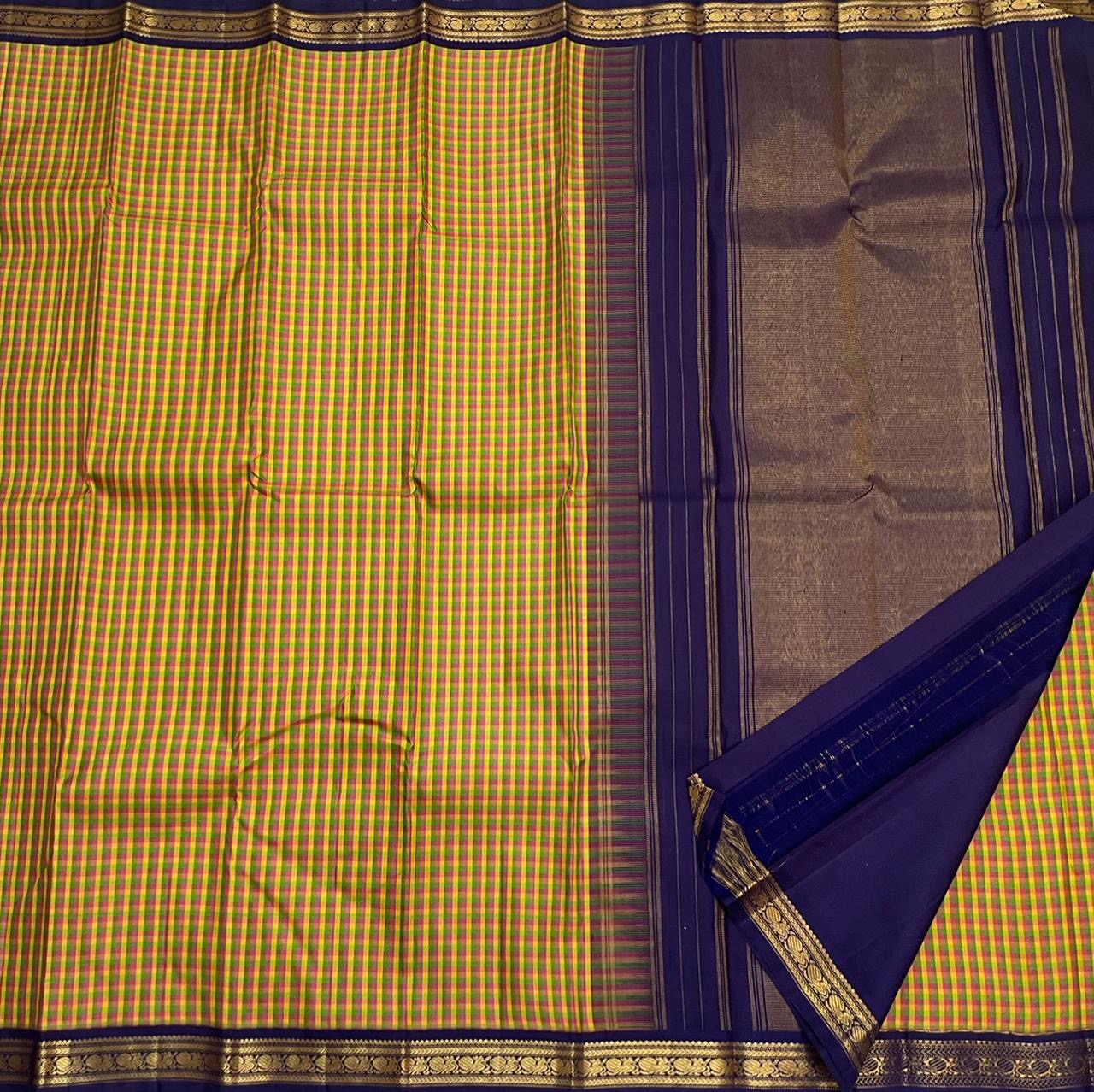 Forest Blossom Kattam — Pure Silk Kanchipuram Saree
Parrot-green, rani-pink & haldi-yellow kattam checks
Deep navy korvai borders with antique gold zari vines
Rich navy zari-striped pallu with tasseled edges
Silk Mark Cert • Free USA Shipping 1 week