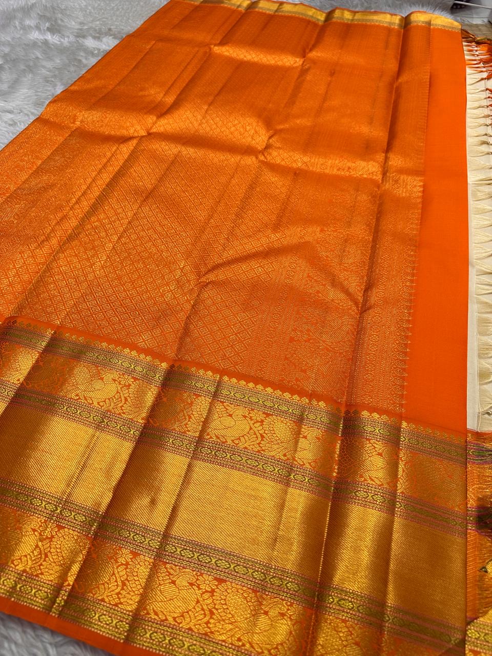 Ivory Marigold — Pure Silk Kanchipuram Saree
Pearl-Ivory Body with Gold Buttas & Kesari-Orange Peacock Zari Border ✨
Silk Mark Certified • Free USA Shipping • Ships in 2 weeks