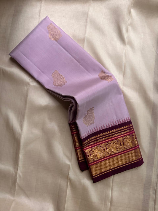 Lavanya Varnam — Pure Silk Kanchipuram Saree
Soft lavender-lilac body with rose-gold paisley buttas and deep wine-maroon korvai borders woven with temple motifs and rich zari.
Silk Mark Certified • Blouse Stitching Available ($30) • Free USA Shipping •