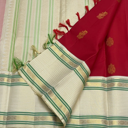 Yazhi Venpattu — Pure Silk Kanchipuram
Kumkum-red body with gold mankolam buttas & ivory korvai borders in mint-green lines ✨
Silk Mark Certified • Ships in Two Weeks • Free Shipping within USA