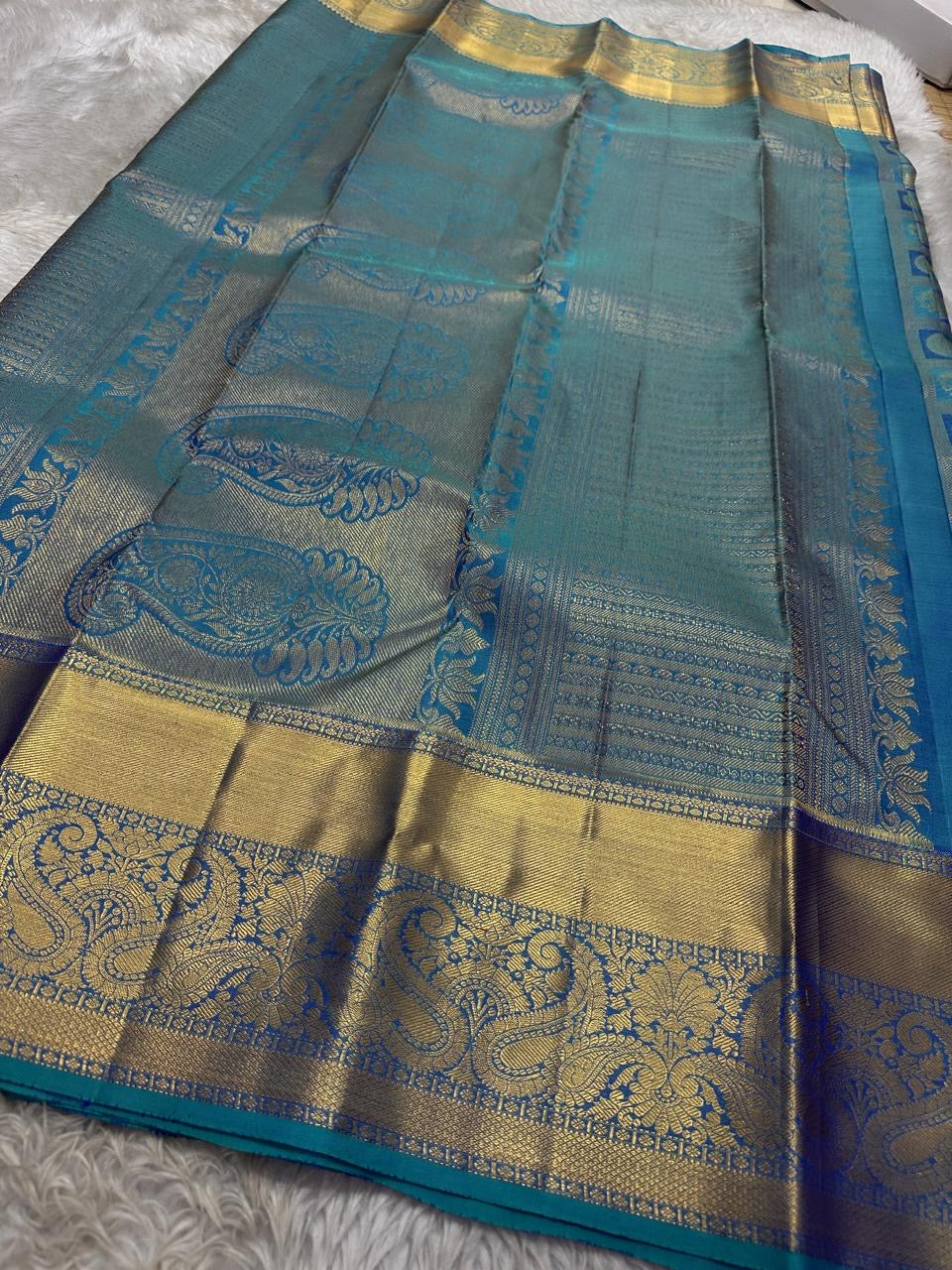 Pure silk KanchiPuram peacock blue with a shot of green elephant and Kamalam Zari checks saree