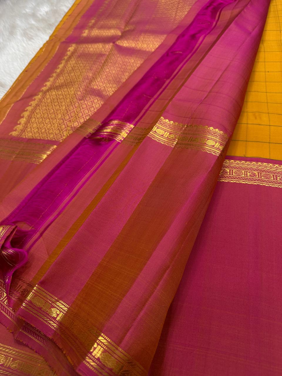 Kesari Checks — Pure Silk Kanchipuram Saree (almost -Mubbagam)
Saffron yellow body in grid kattam weave with radiant pink borders and zari detailing
Silk Mark Certified ✅ • Free USA Shipping • Ships in Two Weeks