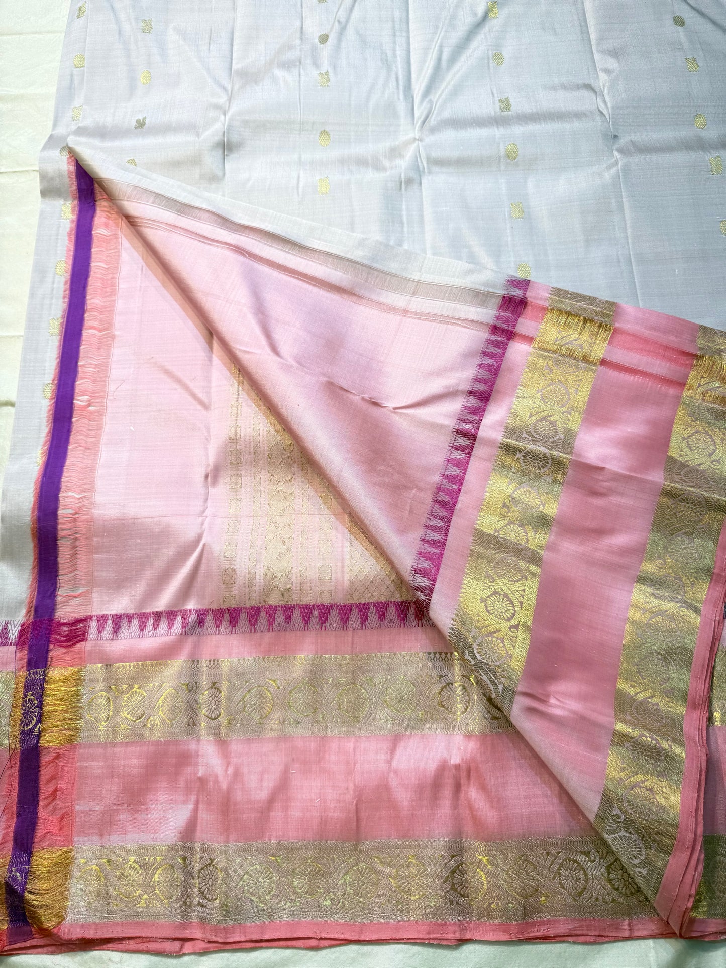 Pink pearl - Pure Kanchipuram Silk with petite chakram zari buttas
Contrast rose-pink border with magenta temple (reku) peaks & floral vine zari
Silk Mark Certified • Free USA Shipping • Ships in Two Weeks
