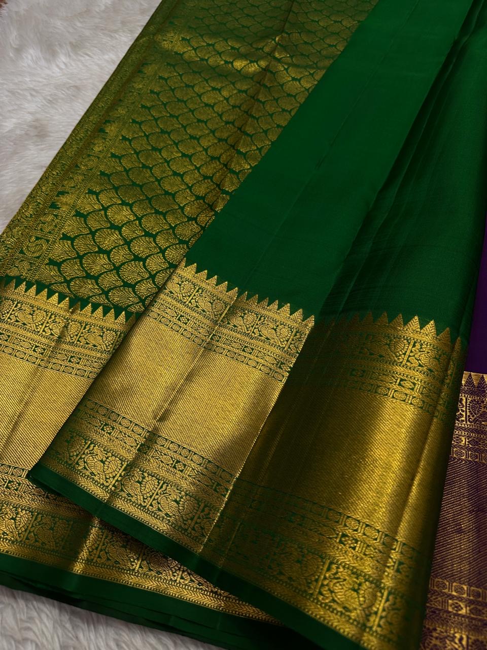 A majestic union of deep purple silk and emerald grace! Mayil chakram butta peacock border