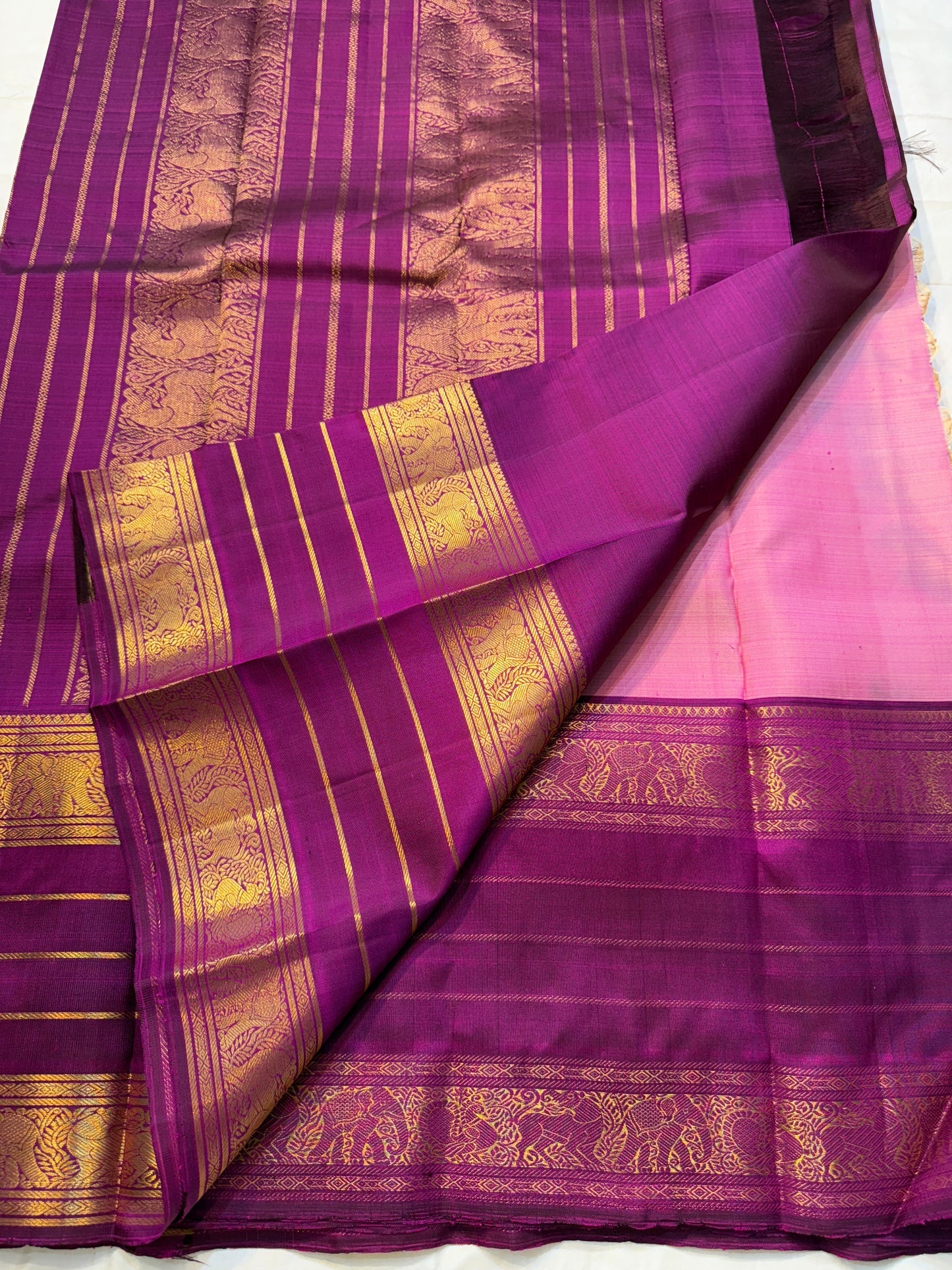 Swarna Sugantham — Pure Silk Kanchipuram Saree
Ombre rose-to-blush pink body with zari paisley buttas and rich rani-magenta borders in gold vine motifs.
Silk Mark Certified • Blouse Stitching Available ($30) • Free USA Shipping • Ships in Two Weeks.