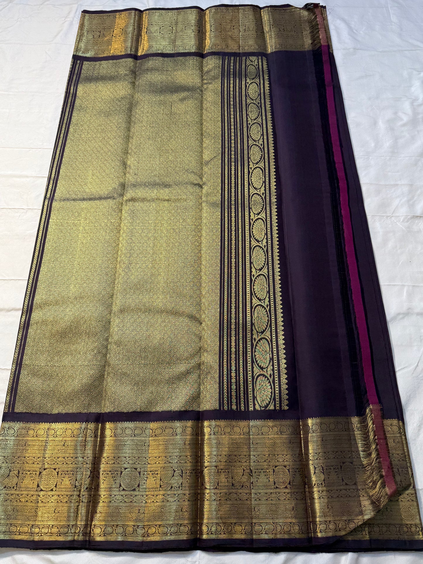 Deep Plum Coin Zari (Pure Kanchipuram Silk)
 Aubergine/plum body with gold chakram & mayil buttas
Self deep-purple border with antique-gold kasu-mālai (coin) motifs
Silk Mark Certified • Free USA Shipping • Ships in Two Weeks