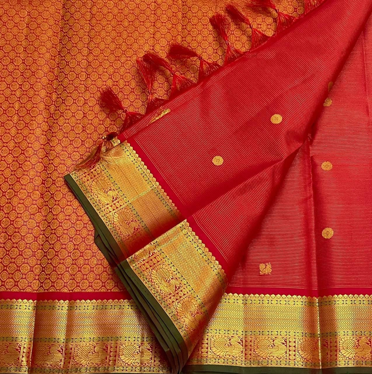 Sringaram Red Vairaoosi – Pure Kanchipuram Silk Saree
Red body with zari coin & floral buttas;
Broad gold border with vairaoosi l & peacock panel; Zari pallu
Silk Mark Certified | Blouse Piece Included | Fall & Pico Done
…read description