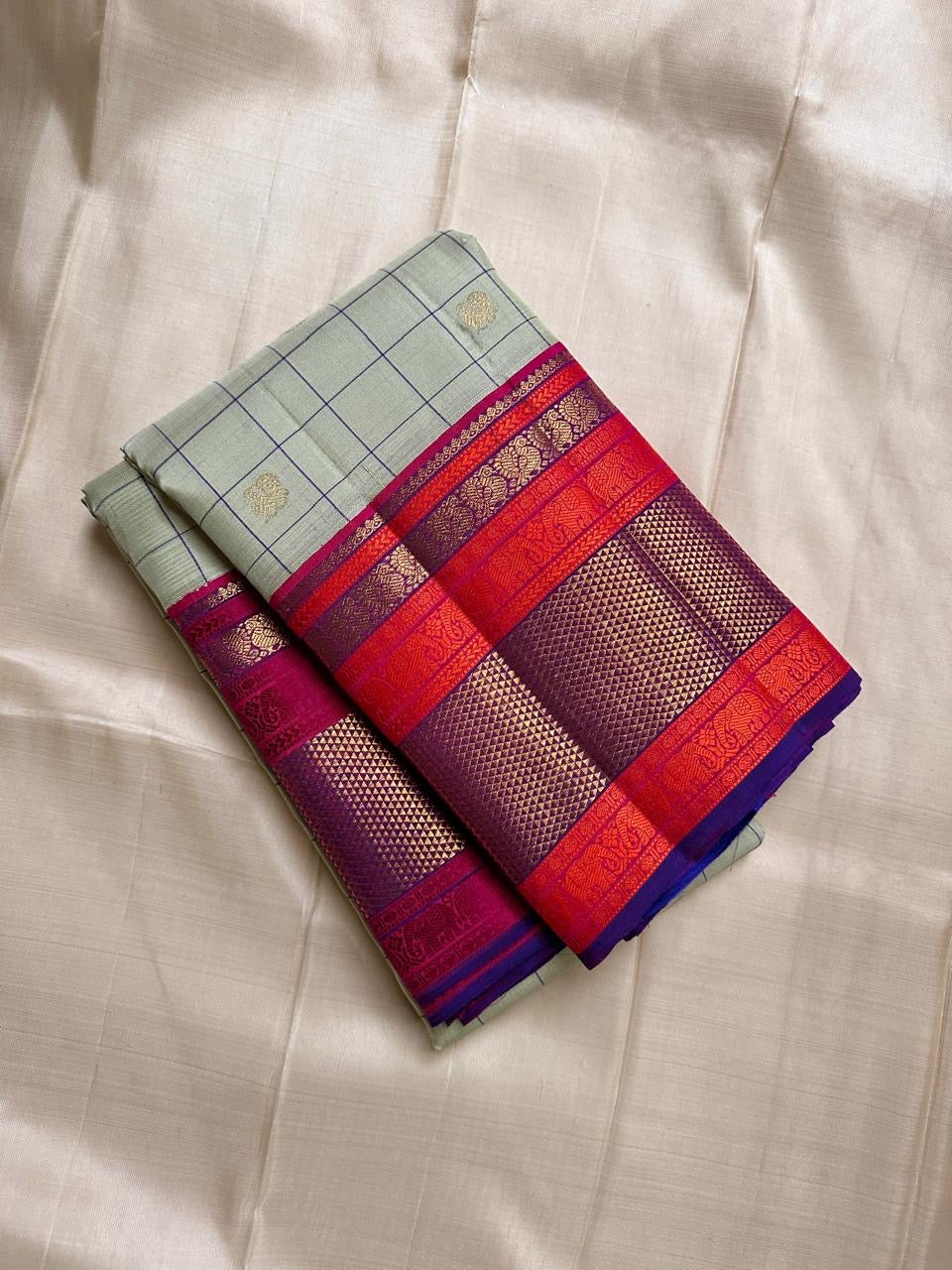 Pastel green pistachio with kungumam red and royal blue border dark blue silk thread checks mayil chakram butta magenta detailed Pallu