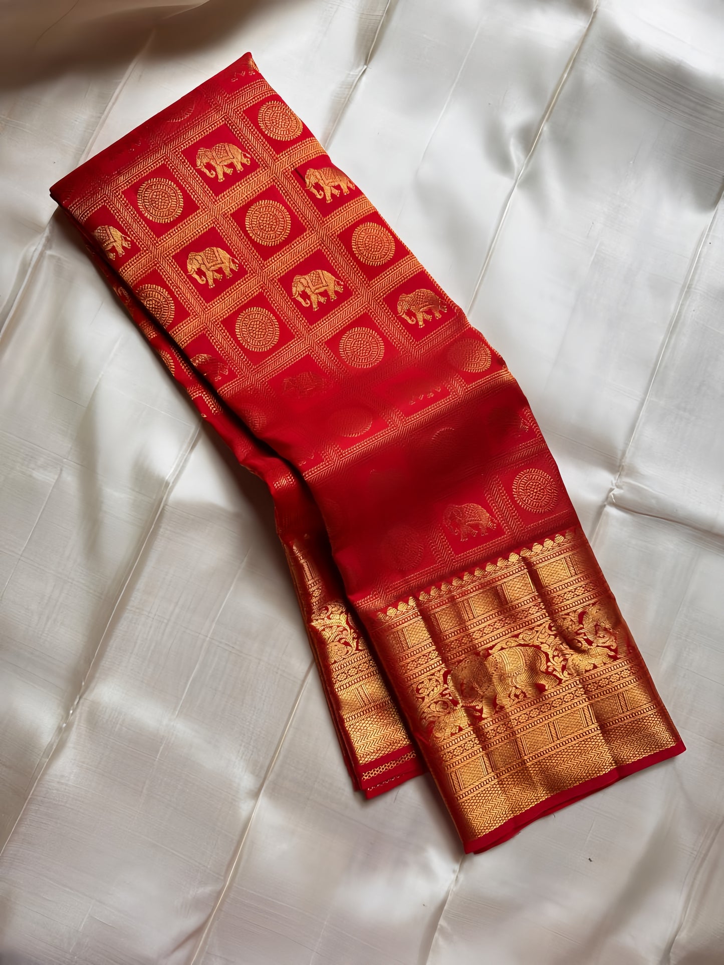 Opulent red Zari kattam with elephant and kamalam motifs spread all over pure silk Kanchipuram saree