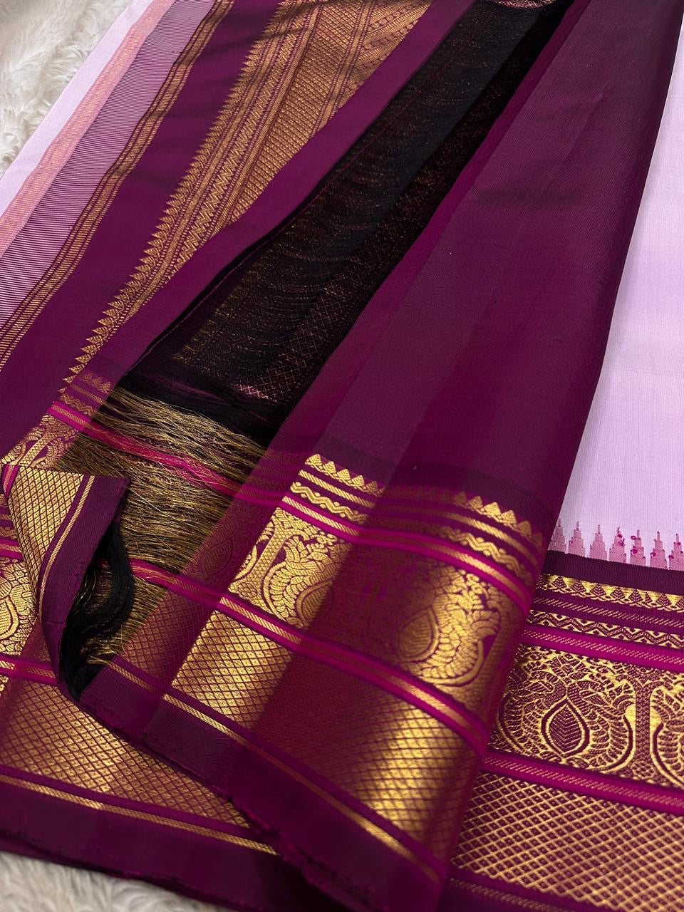 Lavanya Varnam — Pure Silk Kanchipuram Saree
Soft lavender-lilac body with rose-gold paisley buttas and deep wine-maroon korvai borders woven with temple motifs and rich zari.
Silk Mark Certified • Blouse Stitching Available ($30) • Free USA Shipping •