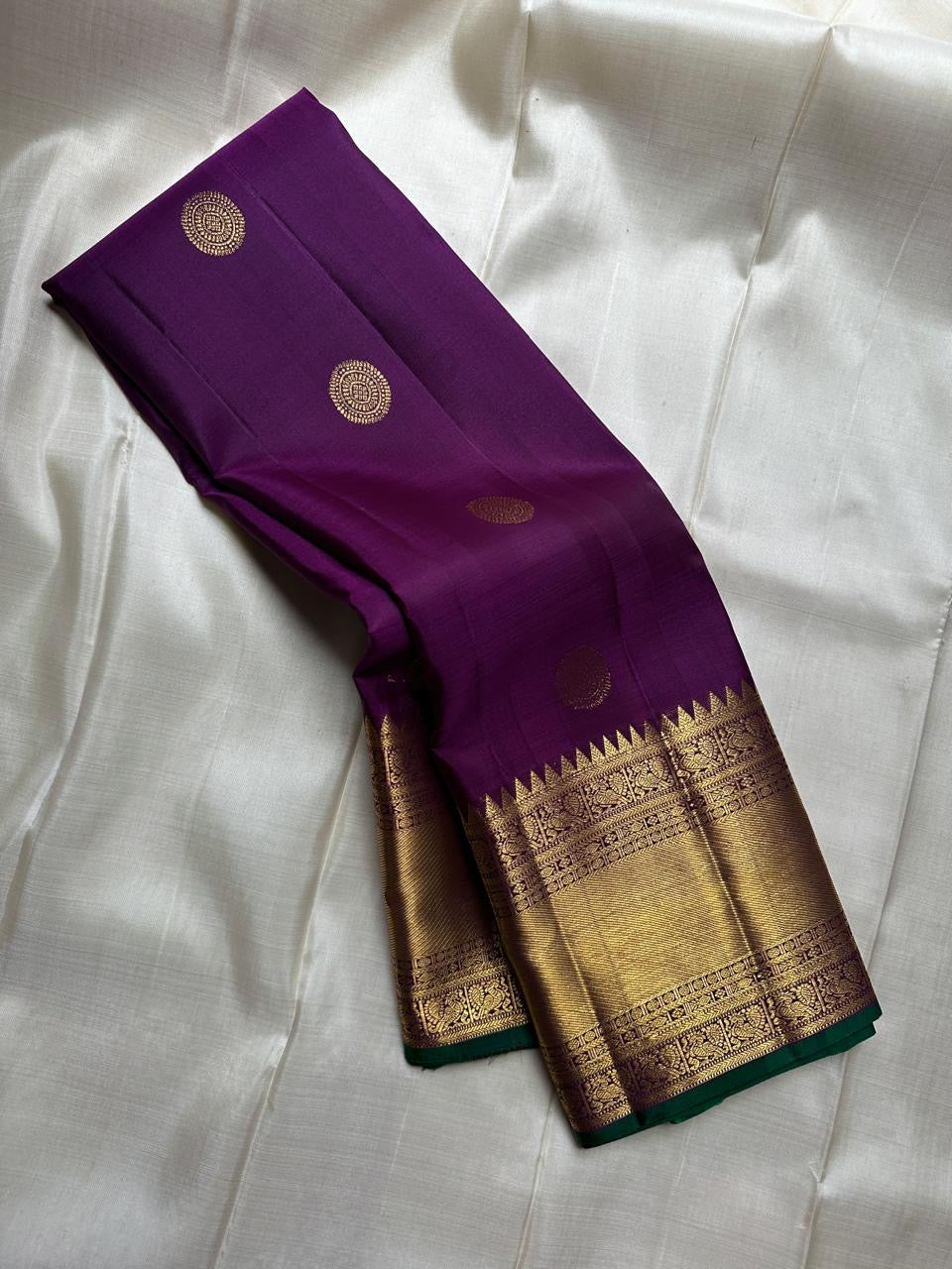 A majestic union of deep purple silk and emerald grace! Mayil chakram butta peacock border