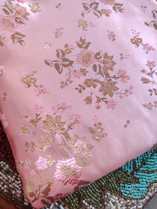 Close-up of structured Parcha silk fabric showing dense weave and refined zari woven work