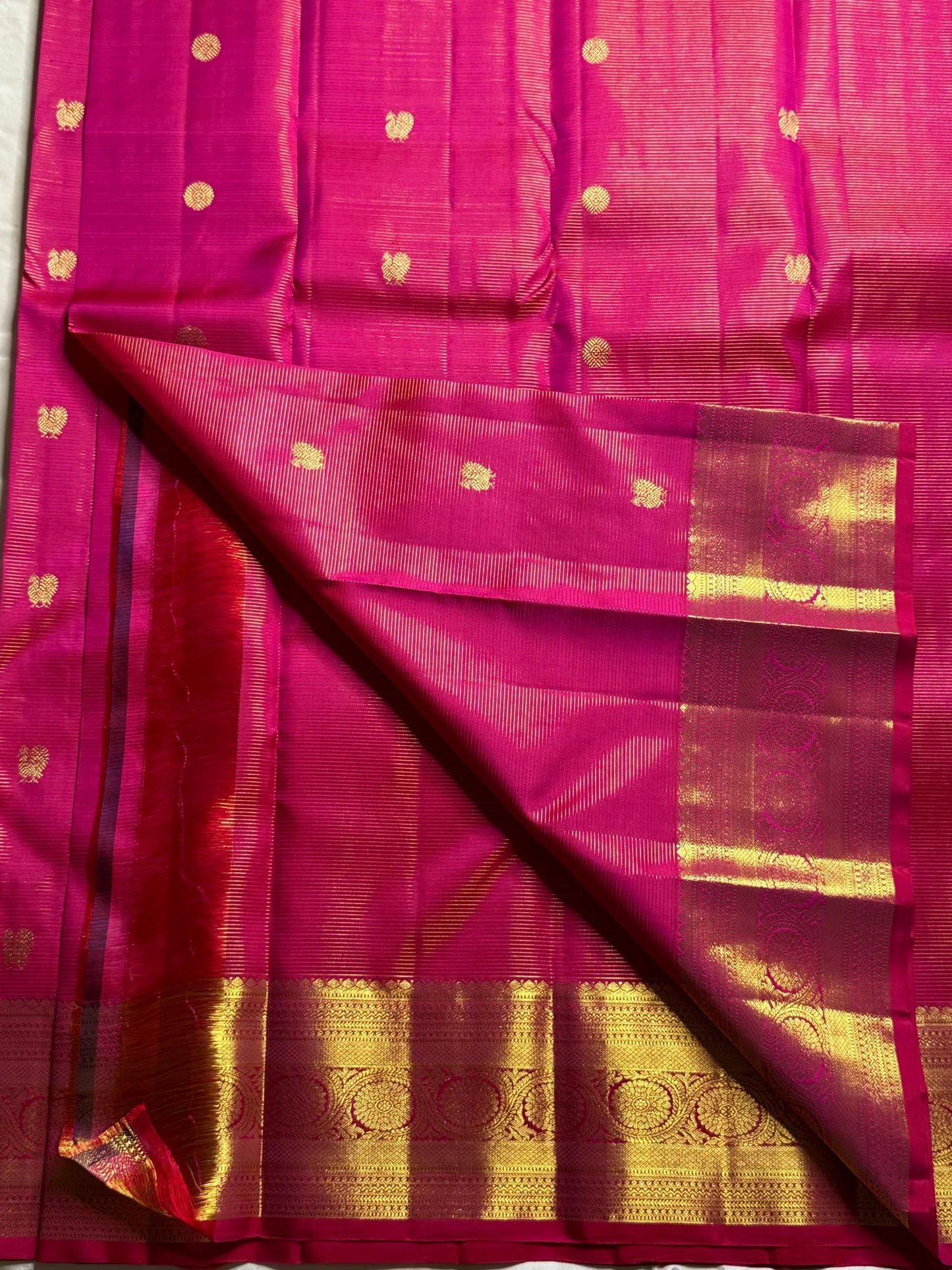 Nakshatra – Radiant pink Vairaoosi Kanchipuram Silk Saree Adorned with Mayil & Chakram Zari Buttas, Featuring an Ornate Kamalam and Floral Vine Zari Border, Flanked by Varisaipet Motifs, and a Pallu Woven with Sacred Thulasi Madams and Regal Kamalams