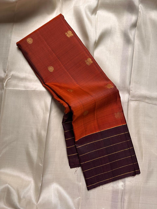 Poornima Kalyani
Burnt Orange & Cocoa Kanchipuram Silk Saree
Zari Buttas · Grid Borders · Silk Mark Certified