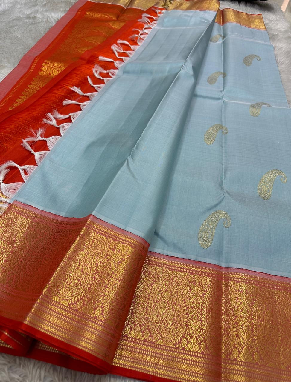 A saree where sky blue melts into sunrise orange—pure silk Kanchipuram magic.