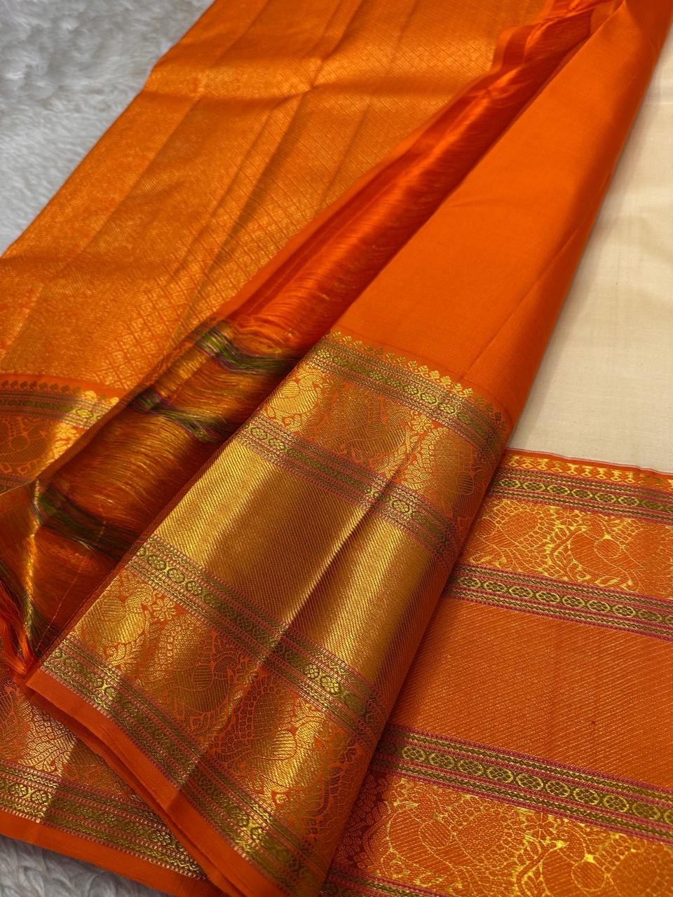 Ivory Marigold — Pure Silk Kanchipuram Saree
Pearl-Ivory Body with Gold Buttas & Kesari-Orange Peacock Zari Border ✨
Silk Mark Certified • Free USA Shipping • Ships in 2 weeks