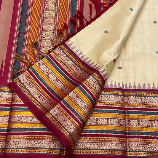Pari Silk Thread Weaving — Pure Silk Kanchipuram
Ivory body with multi-color silk thread buttas (teal, wine & magenta)
Korvai contrast wine-magenta borders with vintage thread stripe panels
Temple gopuram inner edge & grand pallu in handwoven silk thread