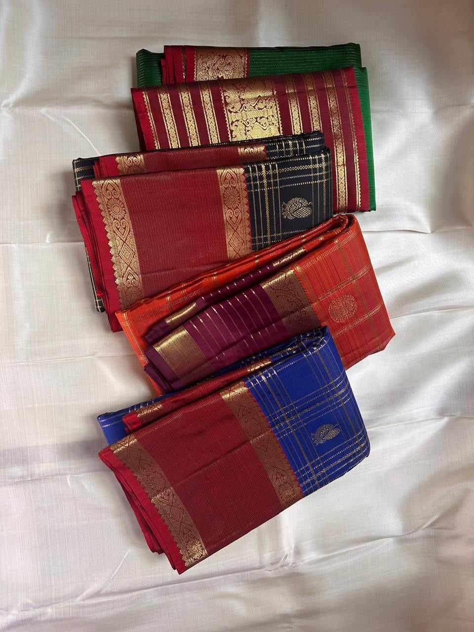 Sapphire Ruby Kattam – Pure Kanchipuram Silk Saree
sapphire blue body with gold kattam checks & buttas
Contrast ruby-red korvai borders with intricate gold zari weave
Grand ruby-red pallu with floral motifs
Silk Mark Certified | ships in 2 weeks