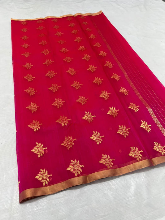 A timeless classic, this Rani pink Chanderi silk saree is a celebration of heritage and elegance. Crafted from lightweight silk with a luxurious sheen, the saree features all-over gold zari floral leafy buttas