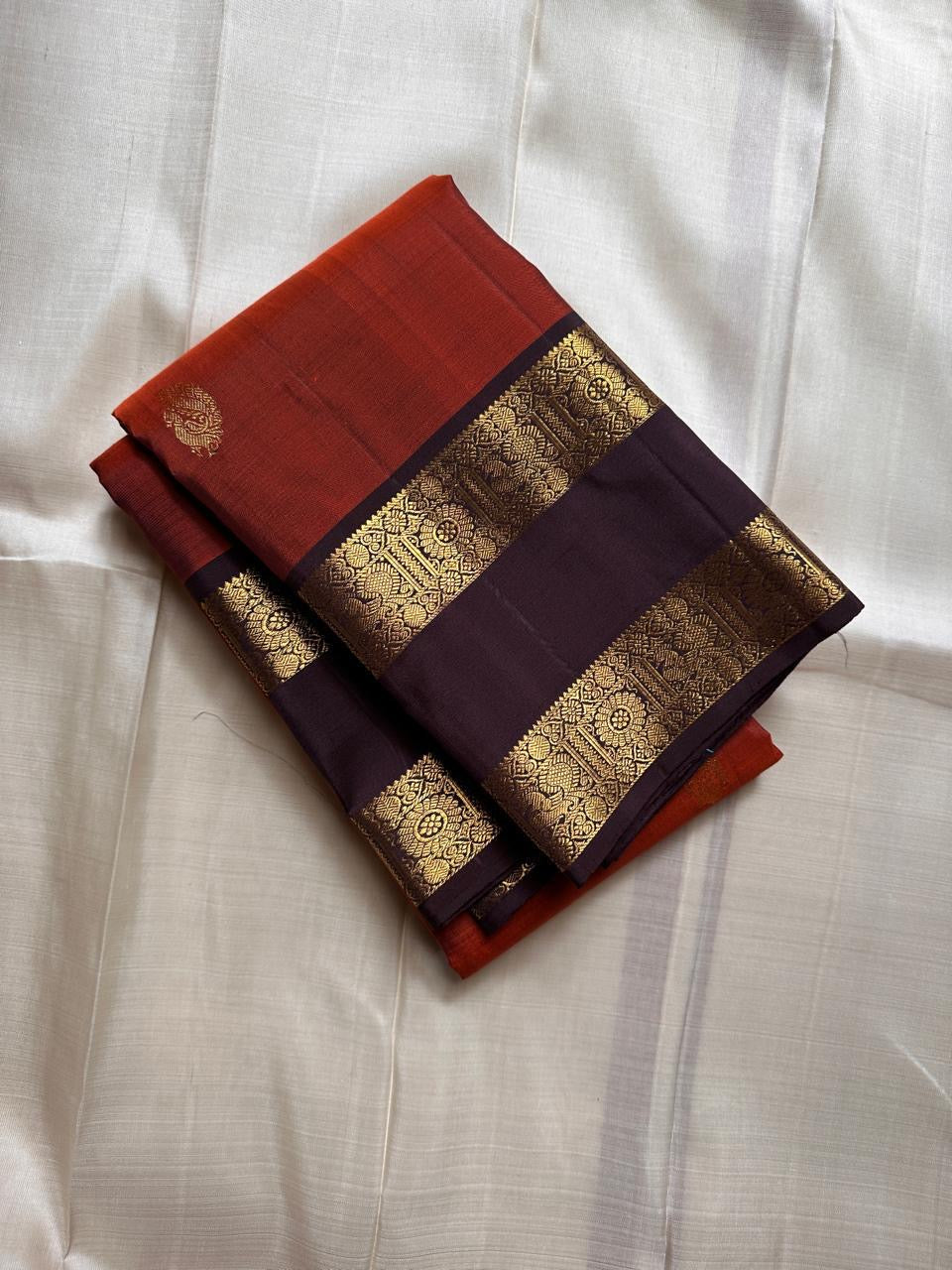 Amudham — Rust Orange Pure Silk Kanchipuram
Rust-orange body with golden paisley buttas & coffee-brown zari borders ✨
Silk Mark Certified • Free Shipping USA • Ships in Two Weeks ✅