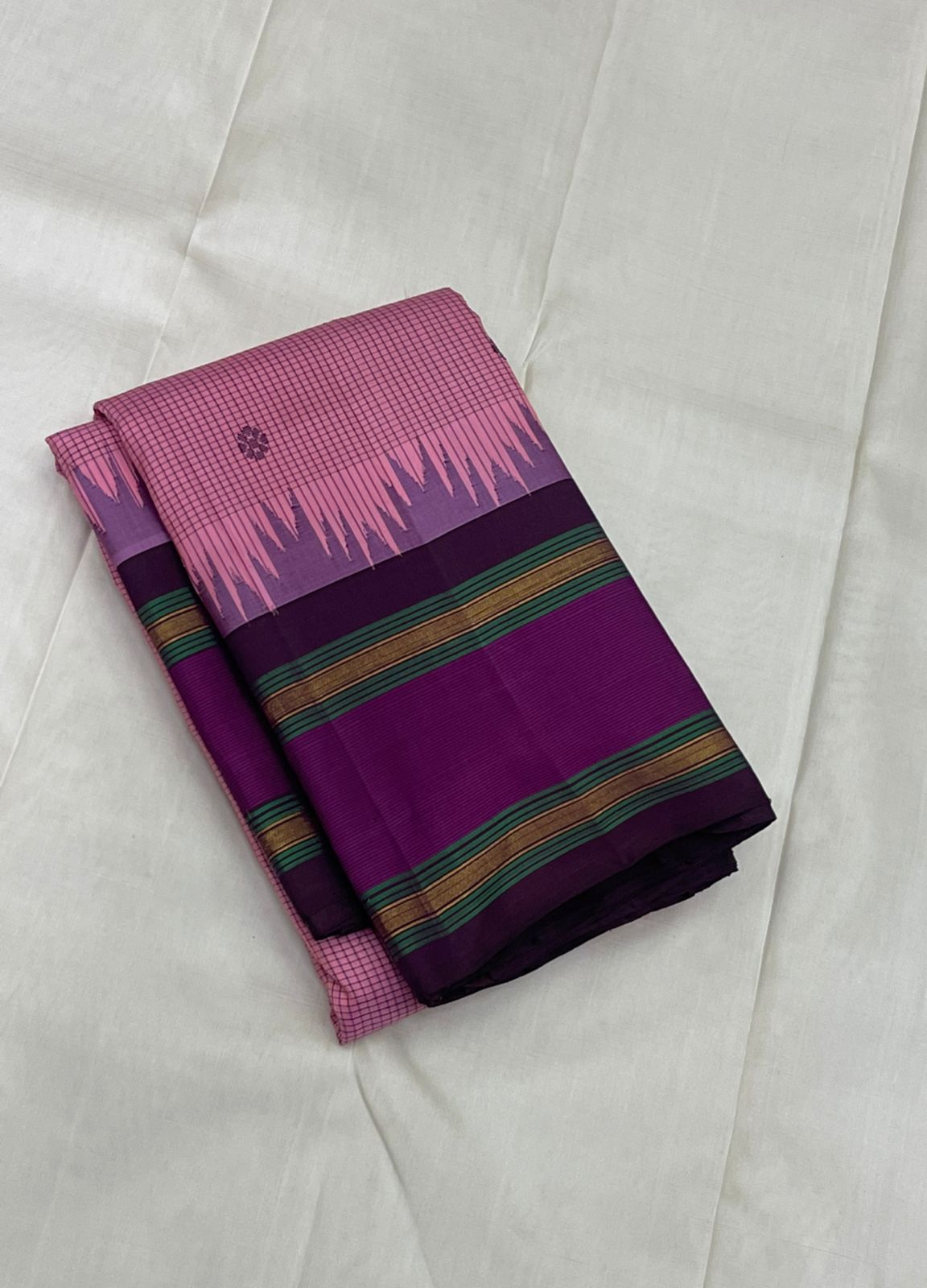 Vadamalli Reku kattam– Pure Silk Kanchipuram Saree
Plum-purple body with gold floral buttas & rettai-pettu borders
Pink checked reku pallu; contrast checked blouse included
Silk Mark Certified | Free Shipping within USA
Ships in 1 Week | Fall & Pico