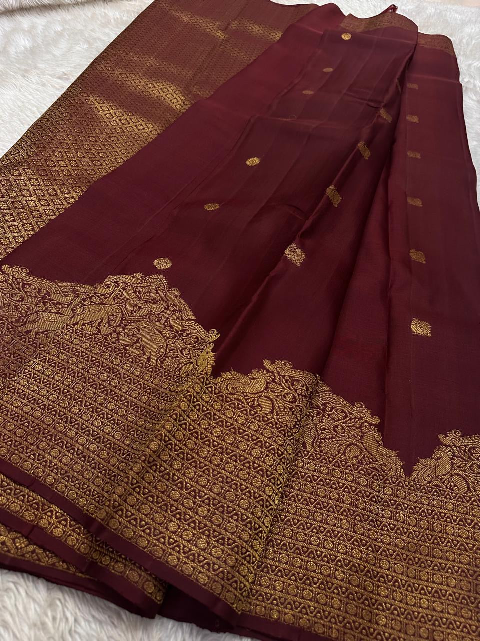 Lotus Glow — Brown | Pure Kanchipuram Silk Saree
A regal brown-maroon canvas adorned with gold zari peacocks, elephants & lotus buttas ✨
Silk Mark Certified • Free USA Shipping • Ships in Two Weeks