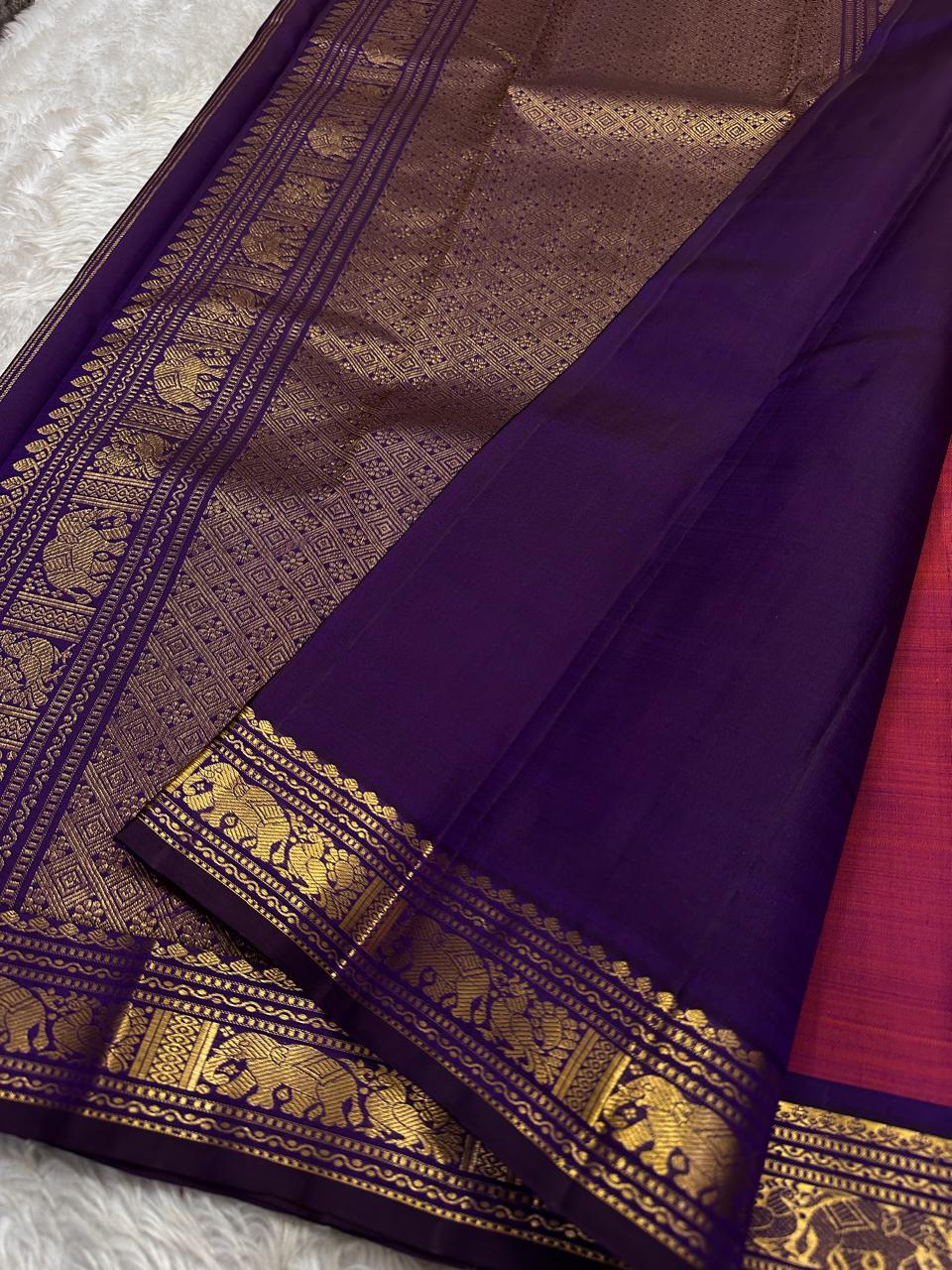 Anju ✨ – Red & Rust-Orange Shot Kanchipuram Pure Silk Saree
with Majestic Elephant & Peacock Motifs
Regal Deep Purple Korvai Contrast Border
Opulent Gold Zari Brocade Pallu