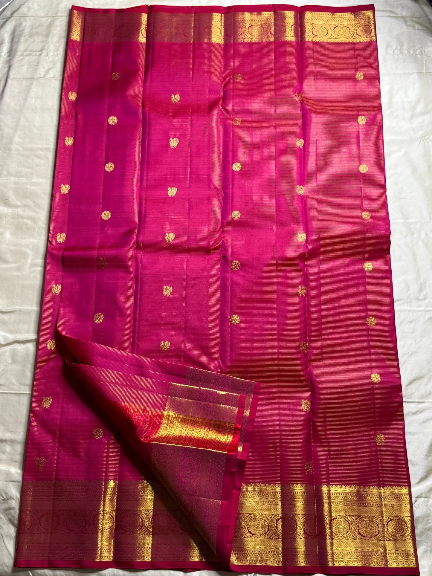 Nakshatra – Radiant pink Vairaoosi Kanchipuram Silk Saree Adorned with Mayil & Chakram Zari Buttas, Featuring an Ornate Kamalam and Floral Vine Zari Border, Flanked by Varisaipet Motifs, and a Pallu Woven with Sacred Thulasi Madams and Regal Kamalams