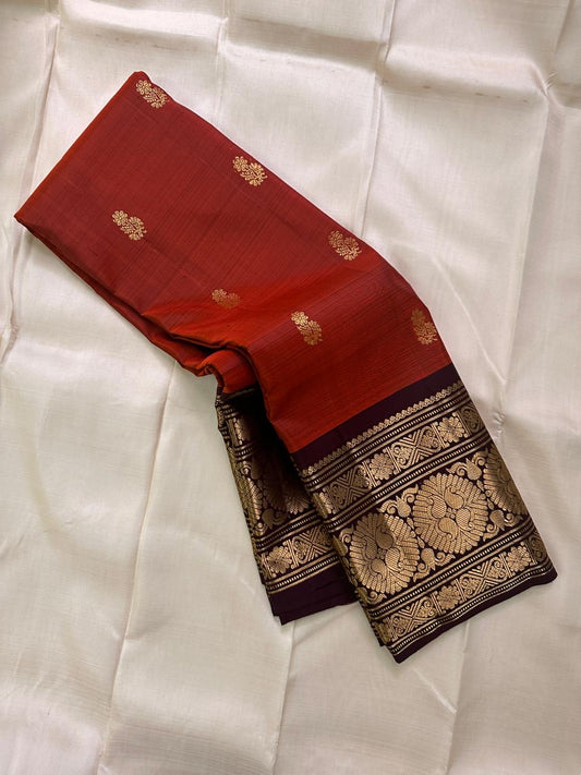 Rust Orange Coffee Brown — Flower Butta | Pure Kanchipuram Silk Saree
Rust-orange body with dainty zari-woven flower buttas and grand coffee-brown korvai borders rich in antique-gold floral medallions.
Silk Mark Certified • Blouse Stitching Available ($30