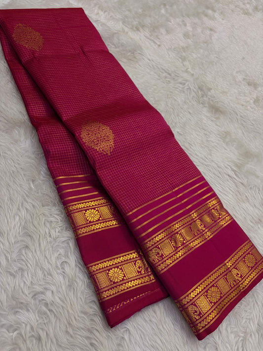 Handwoven Kanjeevaram saree featuring raspberry magenta body with fine zari kattam grid detailing