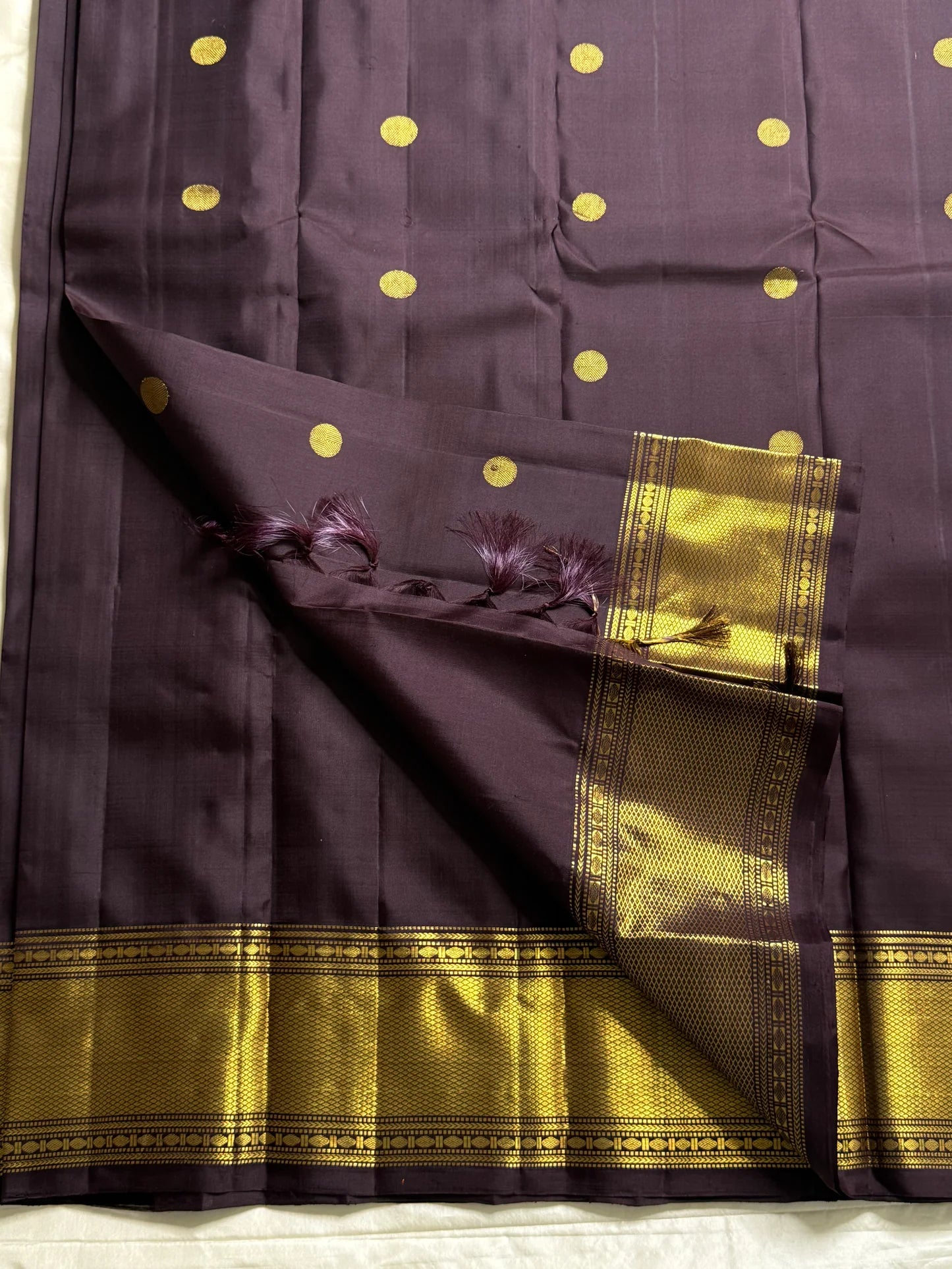 Nagavalli – A Midnight Jamun Dream in Kanchipuram Silk, Woven with Gold Coin Buttas, Temple-Inspired Arai Maadam Border, and Rudhraksham Seer in Lustrous Zari