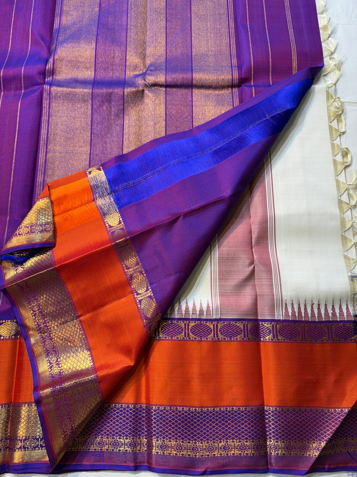 Ivory Temple Glow – Pure Kanchipuram Silk Saree
Ivory Body with Saffron Temple (Gopuram) pillayar moggu
Amethyst-Purple Zari Border with Floral Vines 🌸
Grand Purple Pallu in Rich Zari
Silk Mark Certified, delivery in 2 weeks