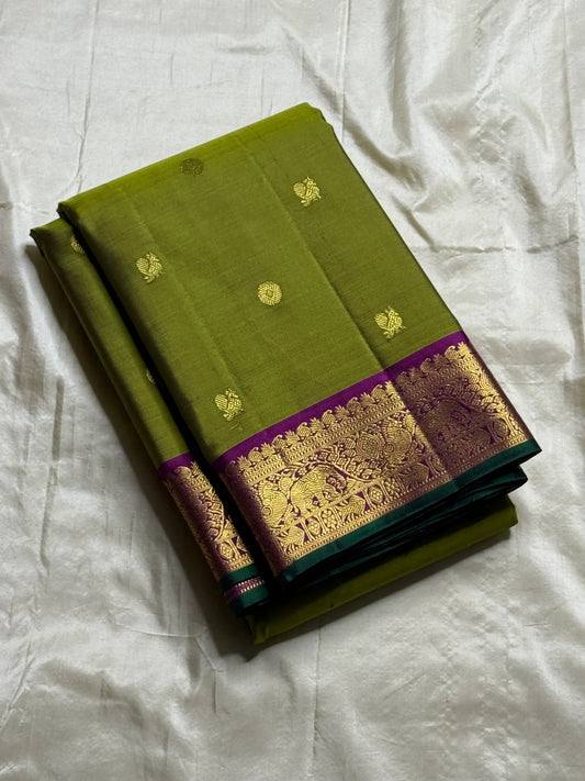 Pachai Mayura Butta – Pure Silk Kanchipuram Saree
Leaf-green body with gold floral and mayura buttas
Magenta korvai border with peacock-vine motifs
Silk Mark Certified | Free Shipping within USA
Ships in 1 Week | Fall & Pico✅ | Blouse Stitching $30